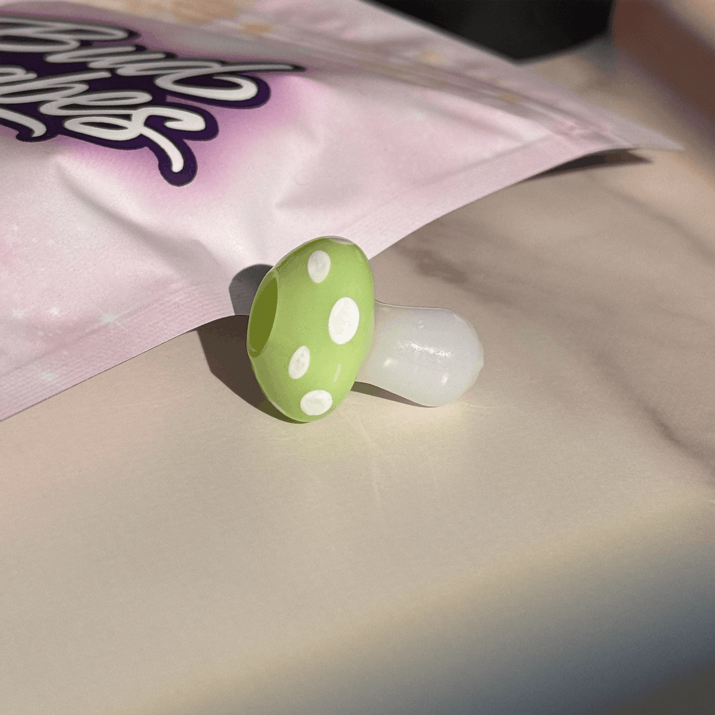 Handmade magic mushroom glass joint holder by BudBabes, styled with flowers
